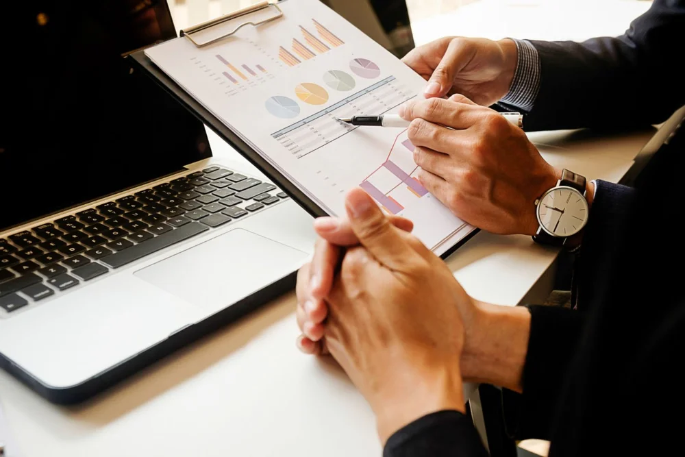 Financial reports and a laptop on a table