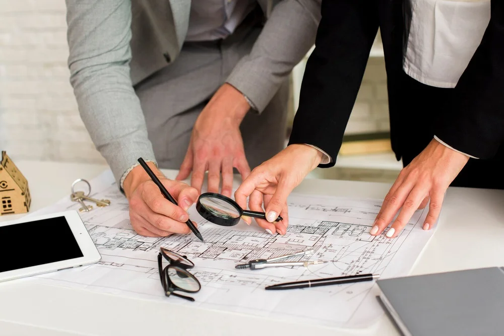 Two people reviewing a construction plan